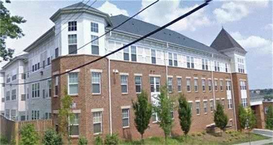a large brick building with a power line in front of it