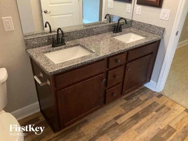 a bathroom with two sinks and a granite counter top