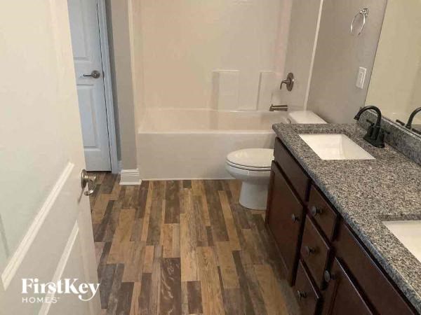 a bathroom with a toilet a sink and a bath tub