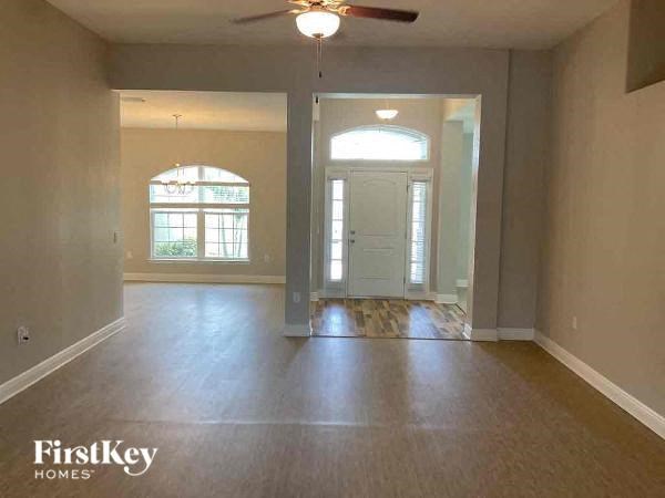 an empty empty living room with a ceiling fan