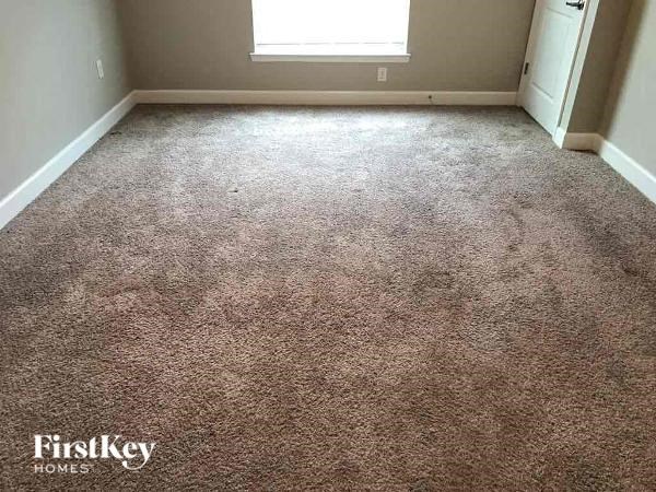 a carpeted floor in a room with a window