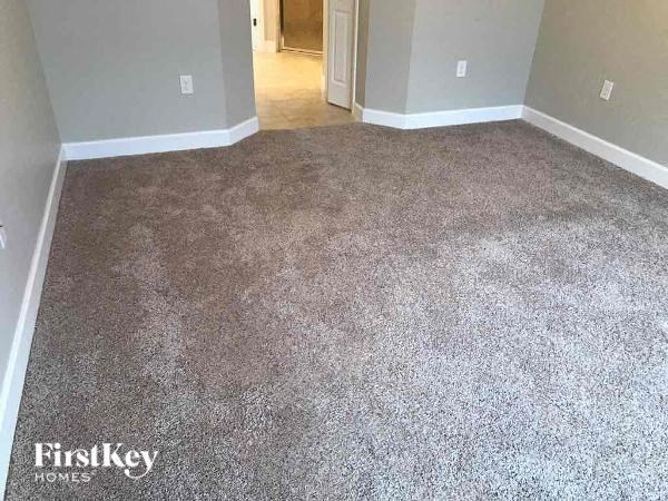 a carpeted floor in a room with a door