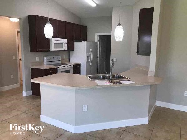 an empty kitchen with a counter and a sink