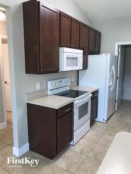 a kitchen with a stove and a refrigerator