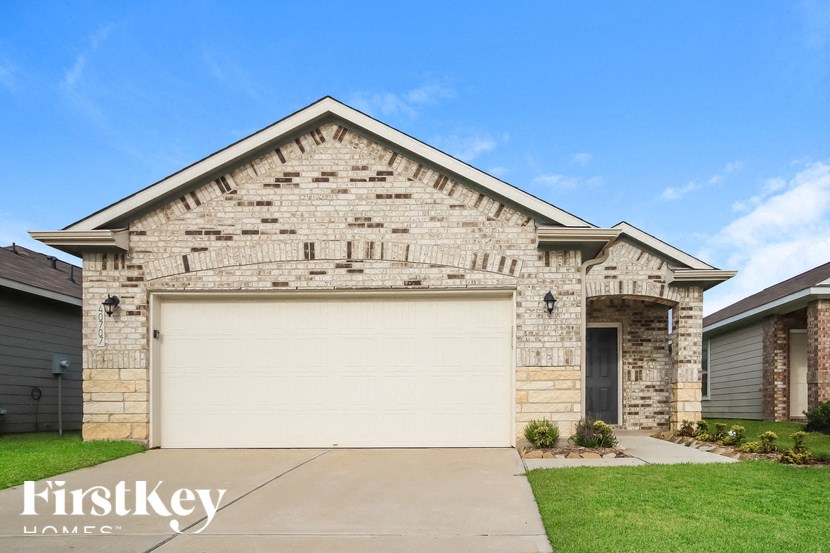 A house with a garage door and a stone facade.