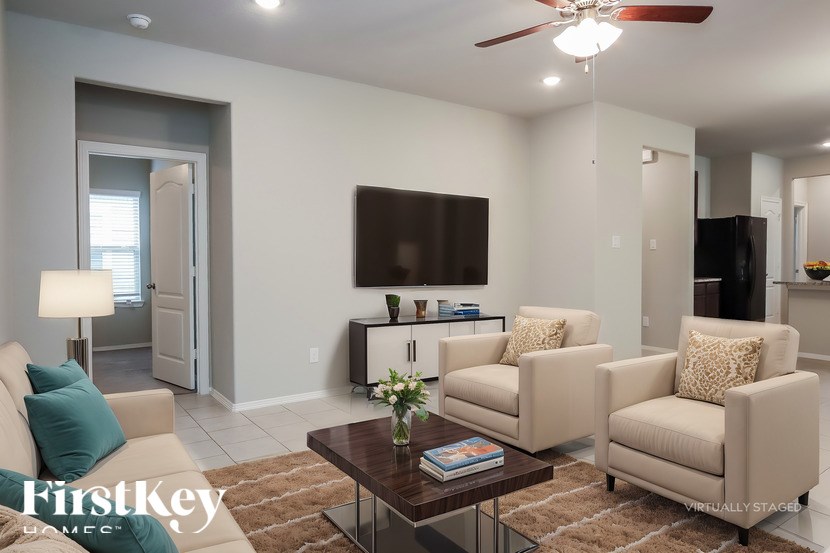 A living room with a couch, chairs, and a coffee table.