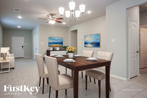 A dining room with a wooden table and chairs.