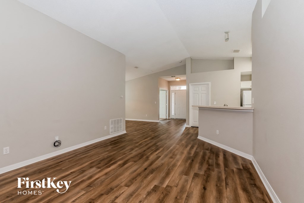 the living room and dining room of an apartment