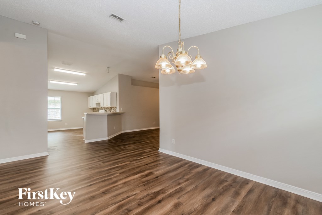 the living room and dining room of an open floor plan