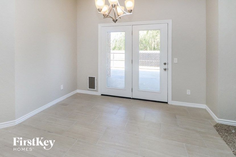 an empty living room with a door to a patio