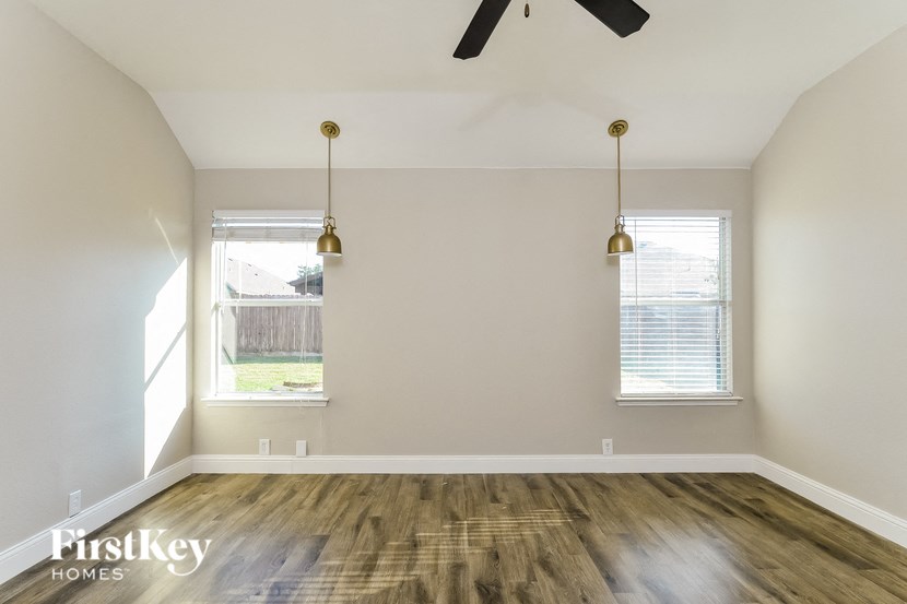 A room with a wooden floor and a ceiling fan.