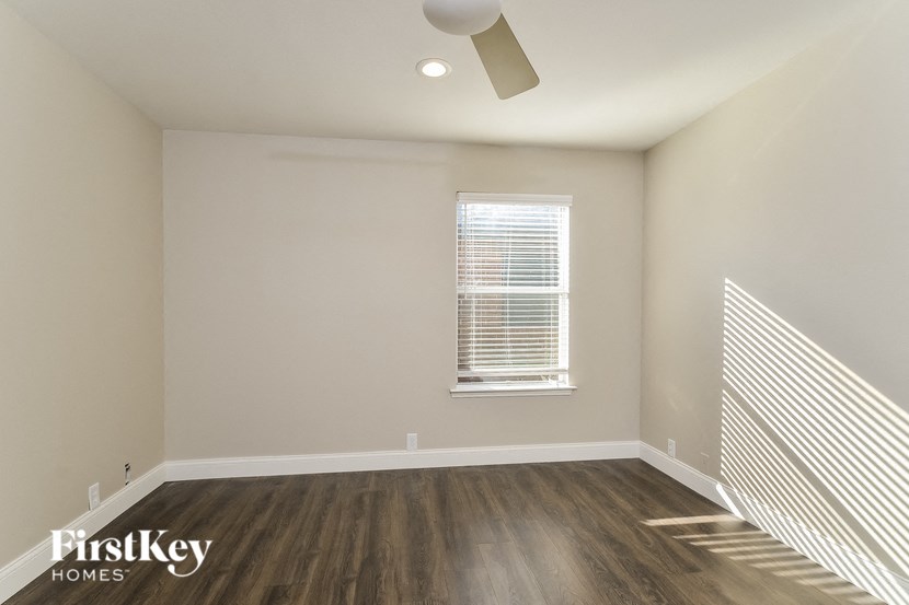 A room with a window and wooden floors.