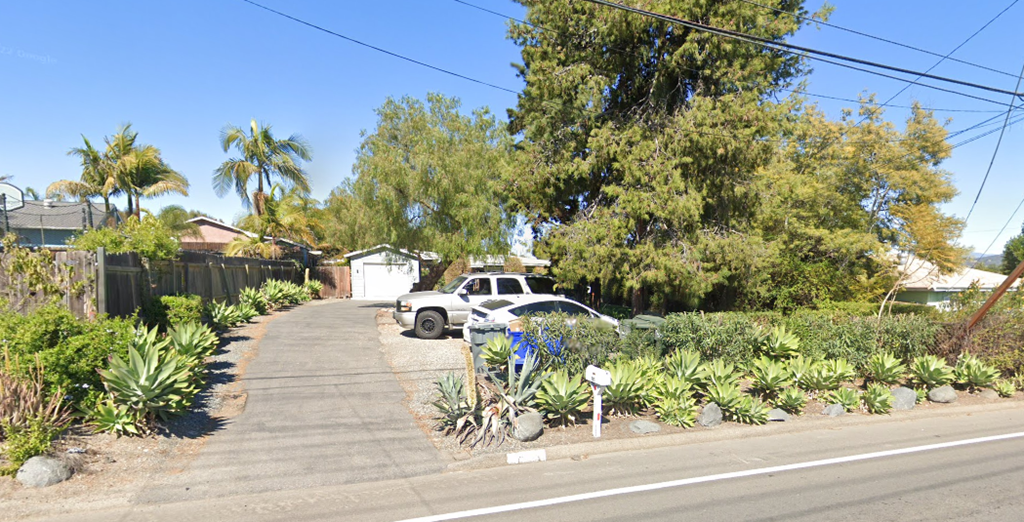 a white car parked on the side of a street