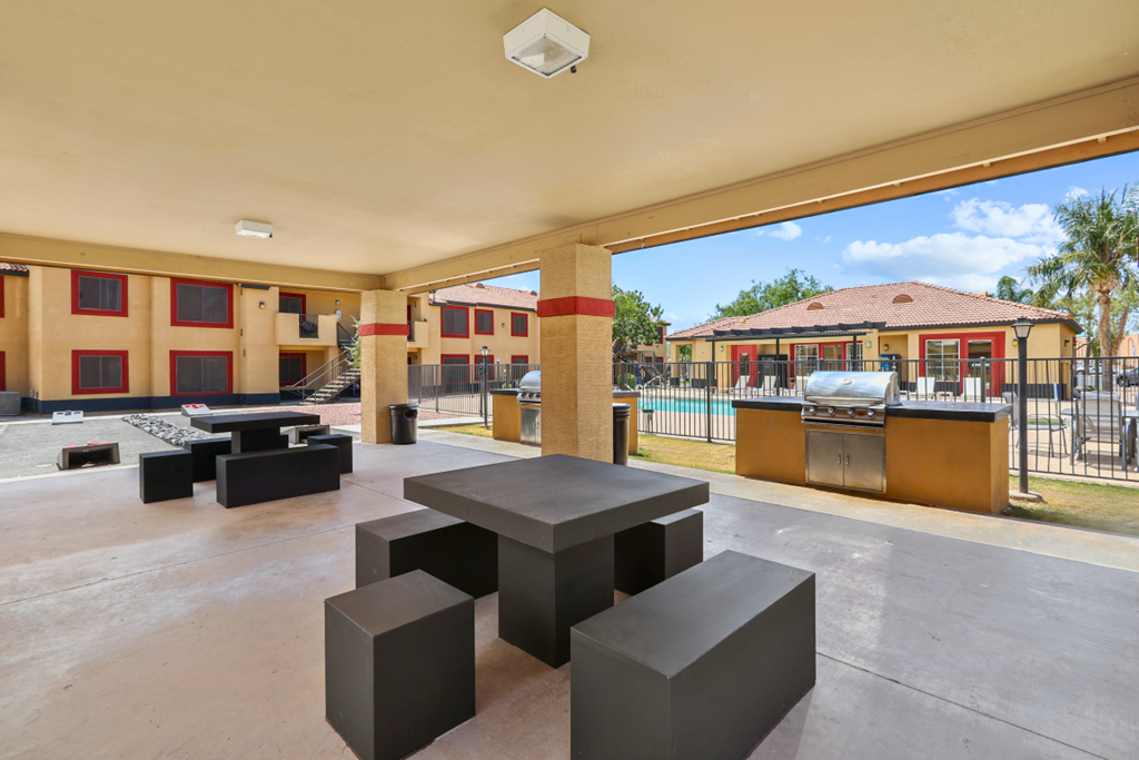 our apartments have a large patio with tables and chairs and a grill