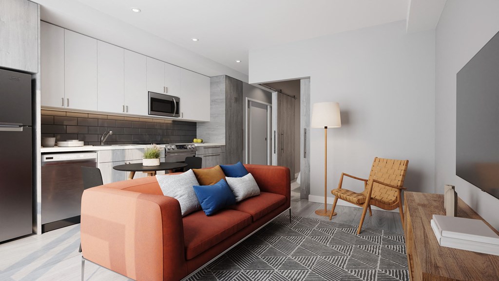 a living room with a couch and a kitchen