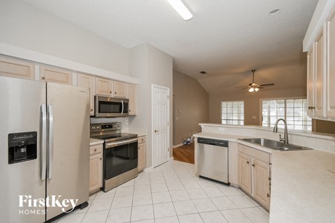 a kitchen with stainless steel appliances and white cabinets