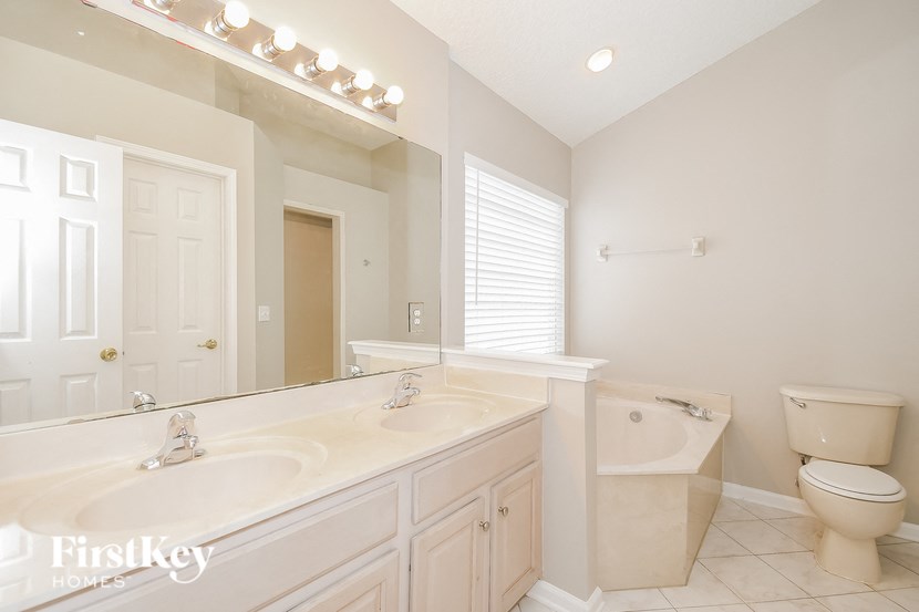 a bathroom with a toilet and a sink and a mirror