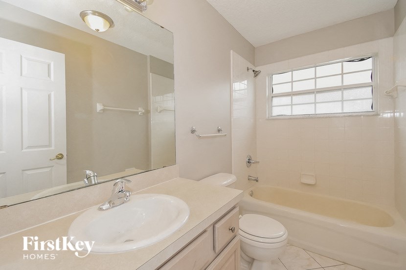 a bathroom with a sink toilet and a bath tub