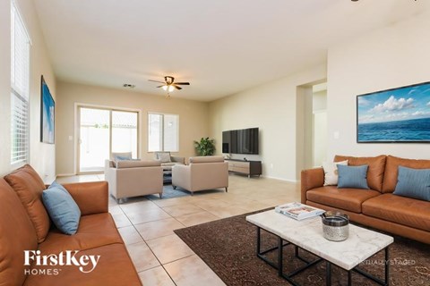 A living room with a brown couch and a white coffee table.