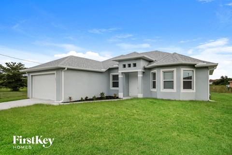a brand new house with a lawn in front of it