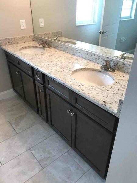 A bathroom with two sinks and a large mirror.