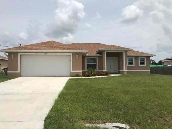 A house with a brown roof and a white garage door.