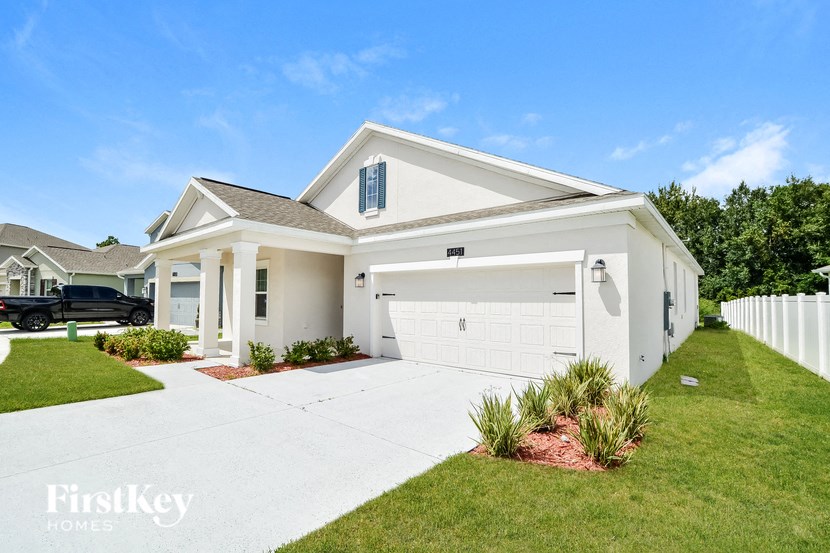 A white house with a garage is shown in the image.