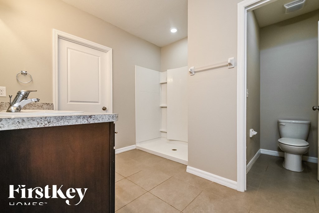 a bathroom with a sink and a toilet and a shower