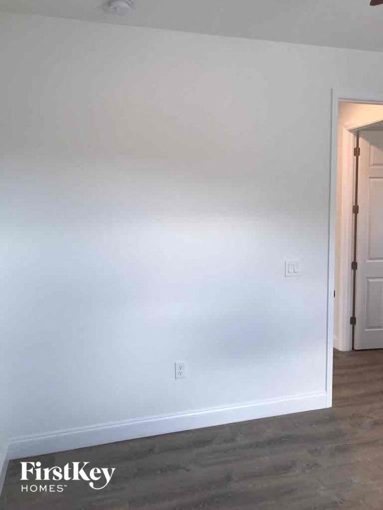 an empty room with white walls and a door