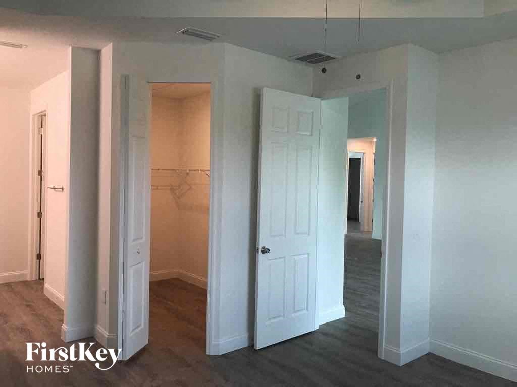 an empty room with a closet and a white door