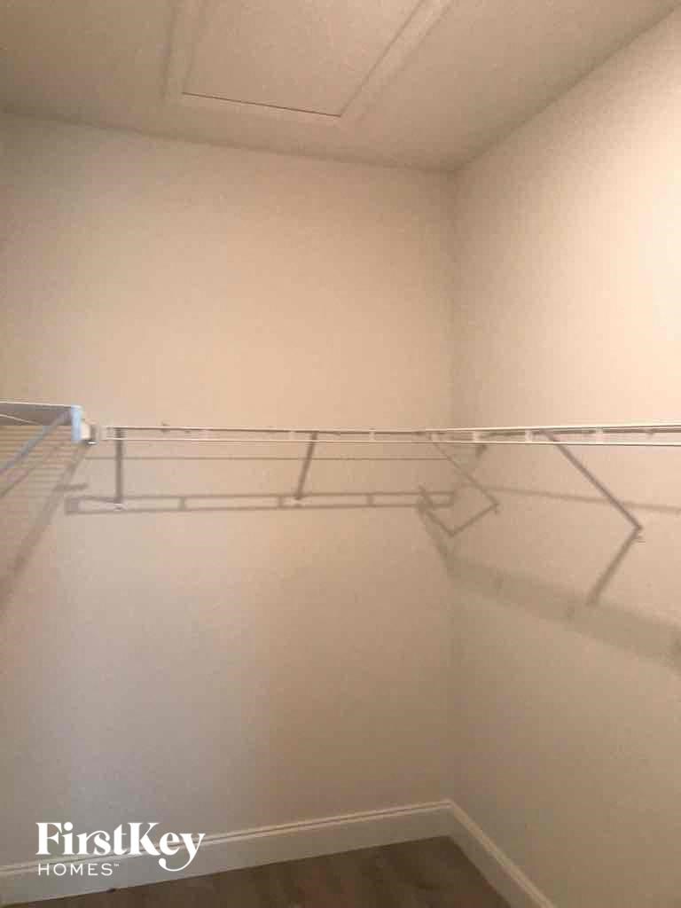 a empty closet with a clothes rack on the wall