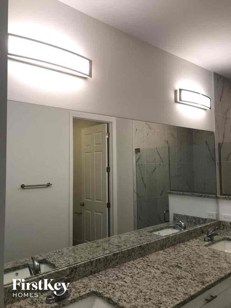 a bathroom with a sink and a large mirror