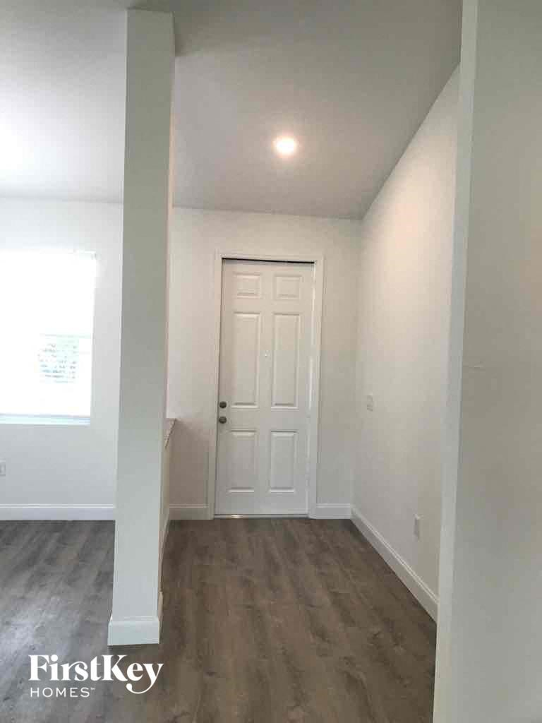 an empty room with a white door and white walls