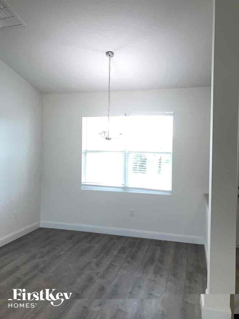an empty room with white walls and a window