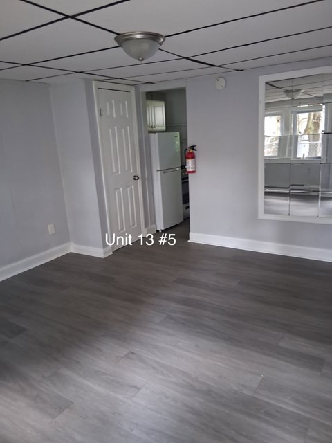 A room with a door and a fire extinguisher.