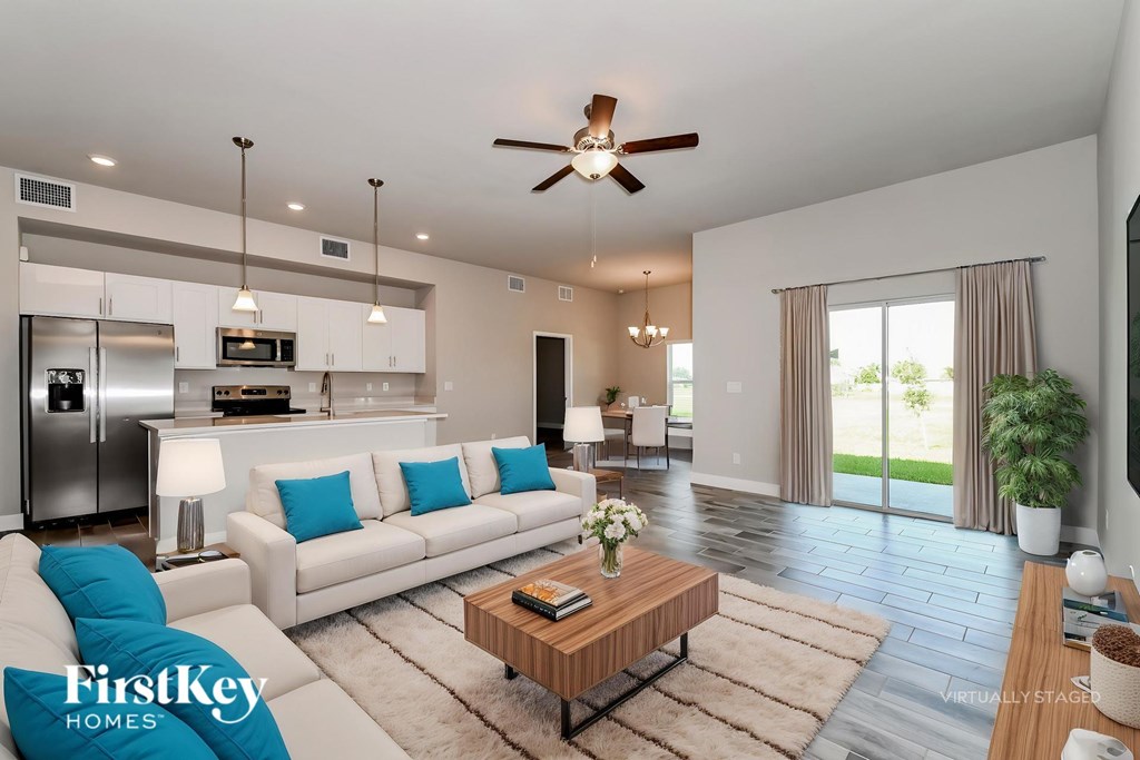 A modern living room with a white sofa and a wooden coffee table.