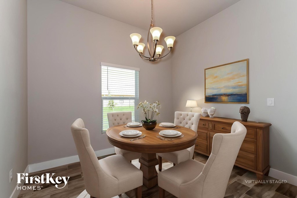 A dining room with a wooden table and chairs.