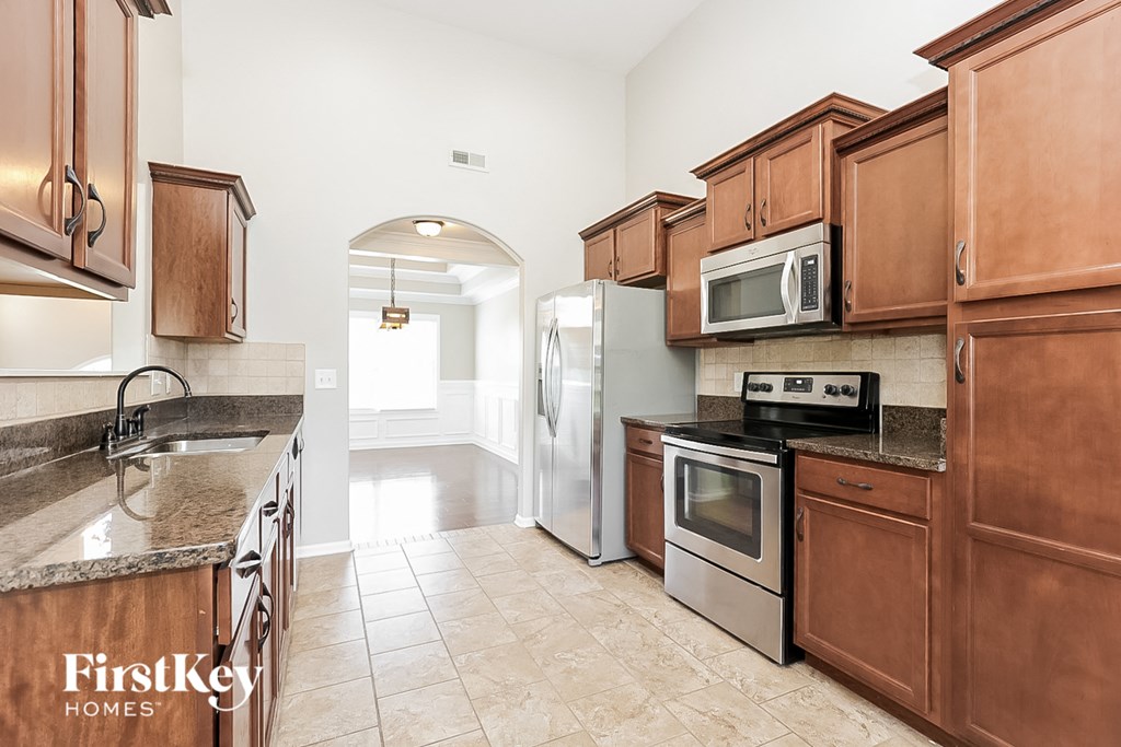 a kitchen with wooden cabinets and stainless steel appliances