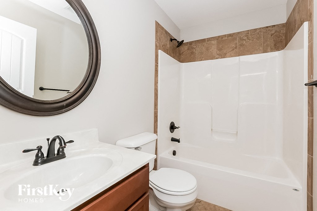a bathroom with a shower and a sink and a mirror