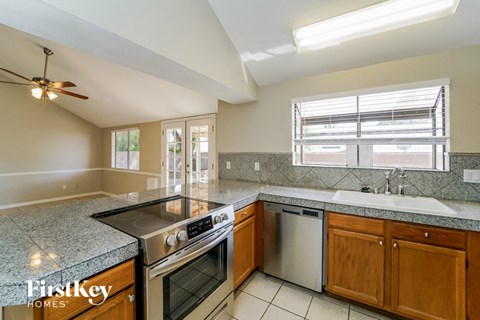 A kitchen with a stove top oven and a dishwasher.