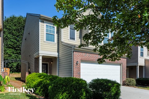 A modern house with a garage is shown in the image.