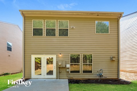 A house with a brown siding and a white door is shown.