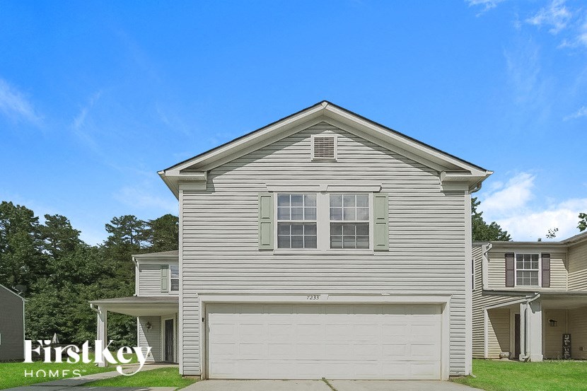 a white house with a white garage door