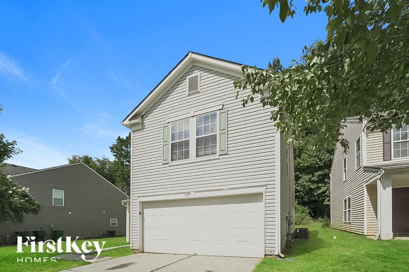 a white house with a white garage door