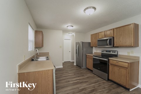 a kitchen with wooden cabinets and stainless steel appliances