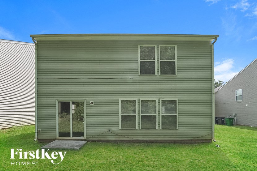 the front of a house on a green lawn