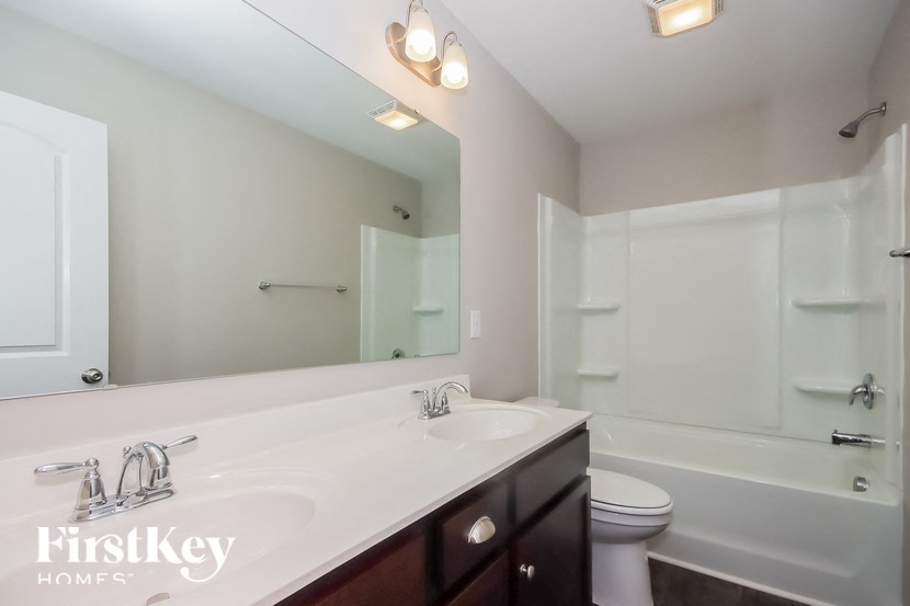 a bathroom with a sink and a toilet and a mirror