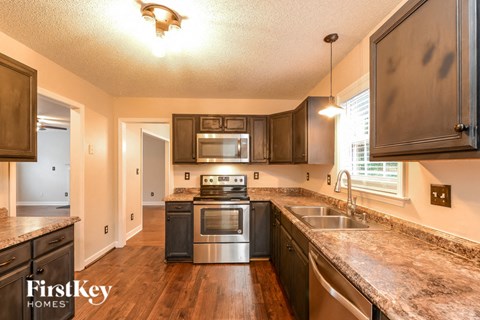 a kitchen with wooden cabinets and stainless steel appliances