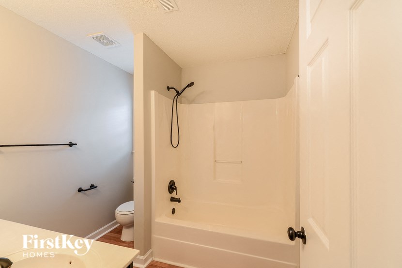 a bathroom with a shower and a toilet in it