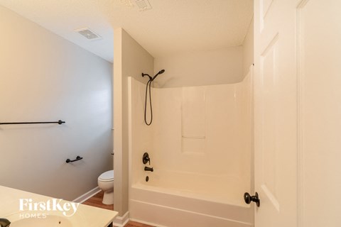 a bathroom with a shower and a toilet in it